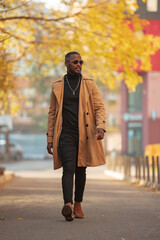 Stylish African American man walking in the autumn city