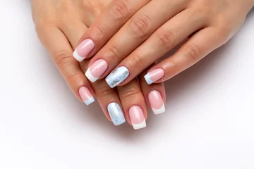 Foto op Plexiglas French manicure with white, light blue and silver matte nail on long square nails close-up on a white background. © dina_shuba