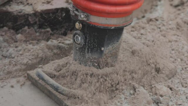 Workers at a construction site, tamping rammer, worker with tamping rammer. Tamping soil