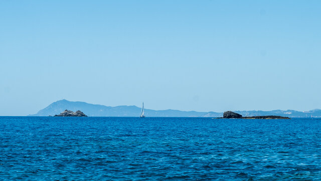 Baot sailing on the Mediterranean sea, between two islands