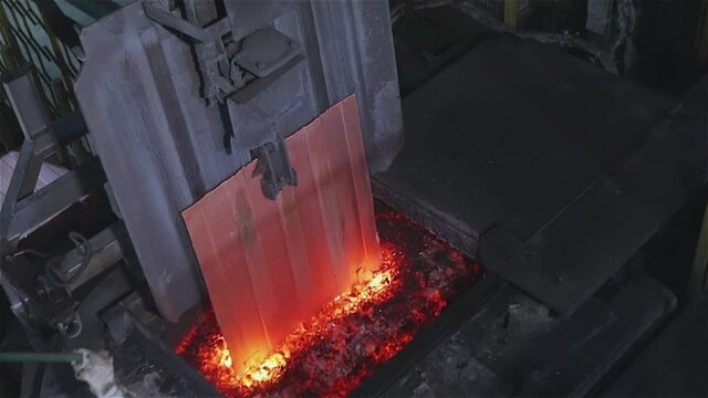 Automated copper feed line to the furnace. The melting of copper in the furnace, the process of melting copper in the furnace.