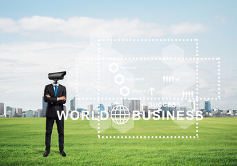 Camera headed man standing on green grass against modern cityscape