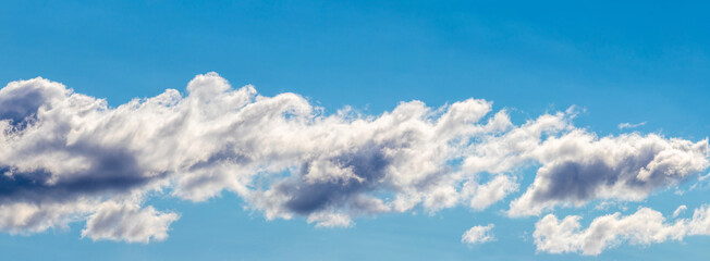 Blue sky with white cumulus clouds, sky panorama