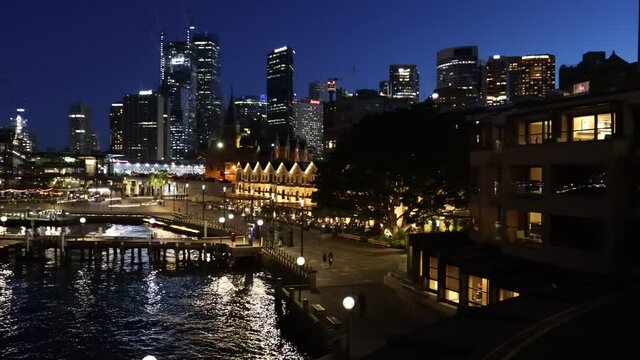 Circular quay overseas terminal waterfront of Sydney city – dark 4k panorama.
