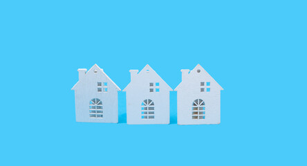 Tree little white houses on blue background 