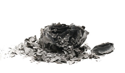 Burned and charred paper document with ashes isolated on white background