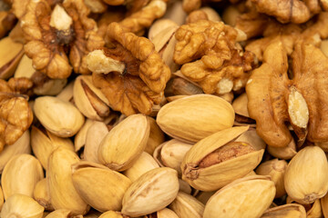 Pistachios and walnuts lie on the sacking. Close up.