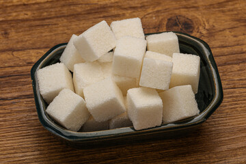 Refined white sugar cubs in the bowl