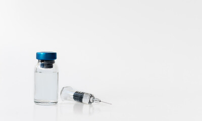 medical syringe and ampoule on white background. copy space.