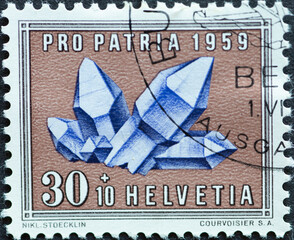Switzerland - Circa 1959 : a postage stamp printed in the swiss showing a purple amethyst grade....