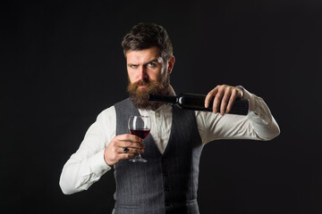 Wine glass. Tasting alcohol. Red wine. Bearded man with glass of wine. Man drinks red wine. Man with Bordeaux.