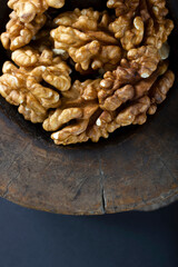 Walnuts in antique, wooden mortar.