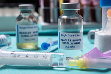 Different vials of triple viral vaccine of measles, rubella and mumps, known as MMR, conceptual...