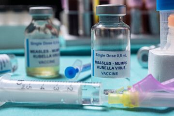 Different vials of triple viral vaccine of measles, rubella and mumps, known as MMR, conceptual image
