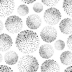 Abstract black and white dotted circles with texture shading effect. Seamless vector pattern grunge style background. Round moon style spheres backdrop with hand drawn elements. Modern all over print.