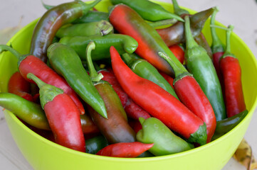 Harvest of bitter red pepper in Minsk on the table in the yard.
