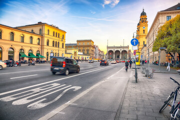 Evening cityscape and view on Theatine Church of St. Kajetan or Theatinerkirche and Feldherrnhalle in Munich - obrazy, fototapety, plakaty