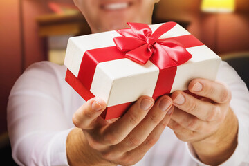 A man gives a gift for a holiday, close-up. Holidays concept