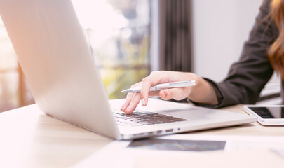 Fototapeta premium Woman working at home office hand on keyboard close up