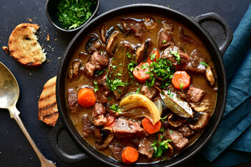 Beef bourguignon - meat stew with vegetables and mushrooms with red wine, traditinal dish of french...