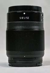black camera lens stading on white background