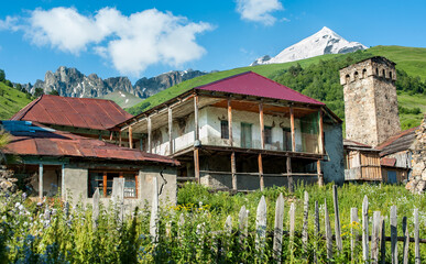 Homes in Adishi, a village in the Svaneti region of Georgia. A medieval watchtower looms on the...
