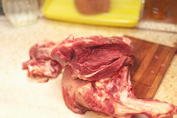 Obraz premium piece of fresh meat leg of pork cut at home in kitchen