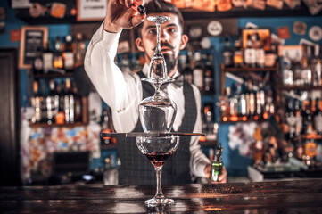 Bartender concocts a cocktail in the porterhouse