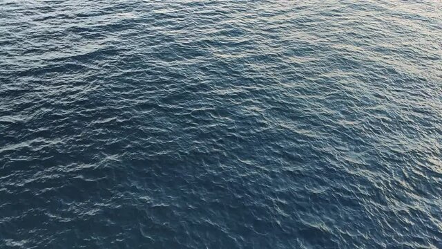 Camera Hangs Over The Blue Open Calm Sea Water 