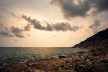 Sea rocks with wave on sunset