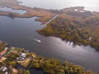 Aerial Shot on Motor Fisherman Boat Floats by Floodplains in Dnieper River near Kherson at Early Autumn