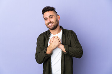 Caucasian man isolated on purple background laughing