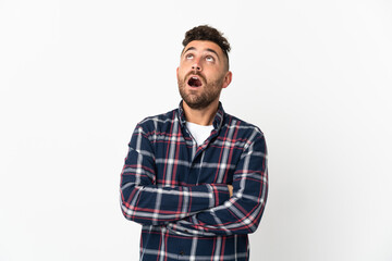 Caucasian man isolated on white background looking up and with surprised expression