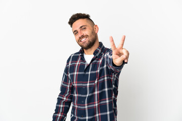 Caucasian man isolated on white background smiling and showing victory sign