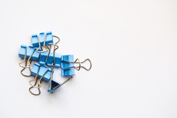 Colored iron paper clips. paper clips with many unique pastel color variants isolated on a white background, Binder clip is a simple device for binding sheets of paper together, metal clips in chaos