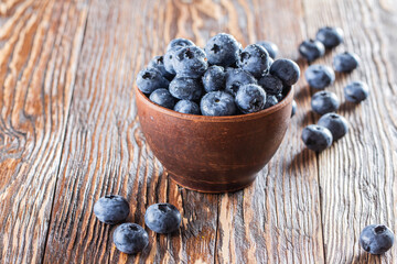 freshly picked blueberries close up with water drops on wood background