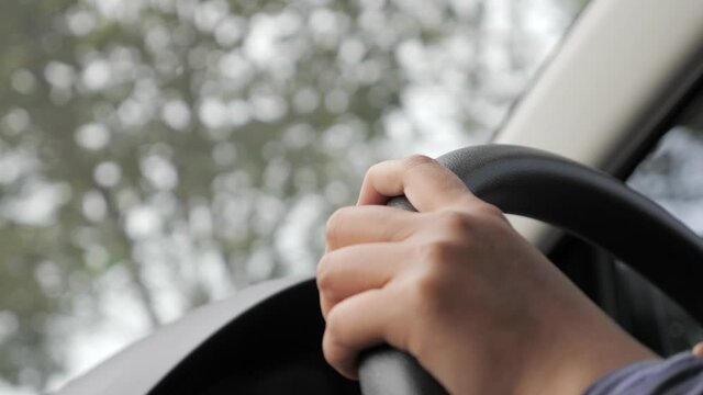 Close up of Hands Driving Car Concept