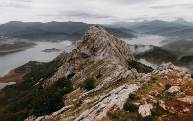 Scenic view of rock formation agaisnt mountains and lake