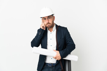 Architect man with helmet and holding blueprints isolated on white background thinking an idea