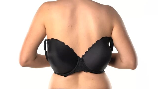 a rear view of a woman setting her bra