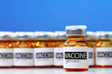 Sars-cov-2 vaccine vial bottles on white table