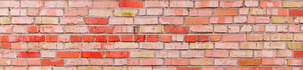 Obraz premium Old wall of cracked red and yellow bricks, panorama