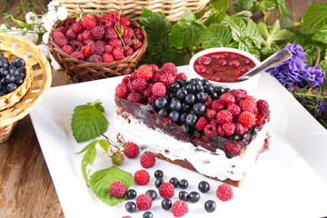 Cream cake with fresh raspberries and blueberries sweet dessert
