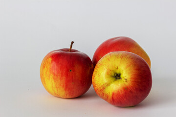 Isolated three red ripe apples on a white background