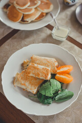 Tortillas with cheese, avocado, herbs and tomato.