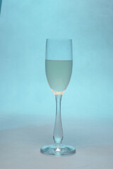 glas with white wine on blue backround