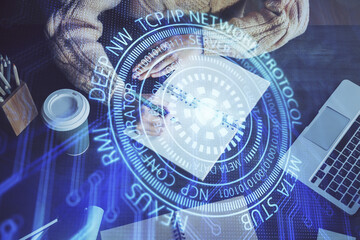 Double exposure of writing hands on background with data solution hologram on front. Technology concept. Close up
