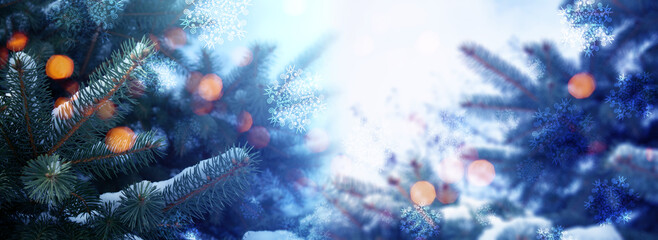 Blurred festive Christmas background. Pine branch close up, blurry bokeh lights, snowflakes.