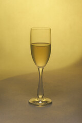 glas with wine one yellow backround