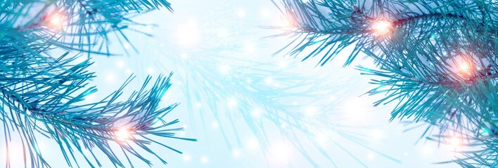 Fototapeta na wymiar Blurred festive Christmas background. Pine branch close up, blurry bokeh lights, snowflakes.
